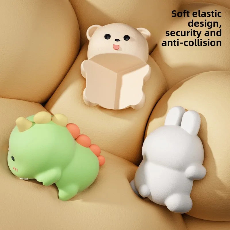 Three cartoon animal-shaped door stoppers on a beige surface with text about their features.
