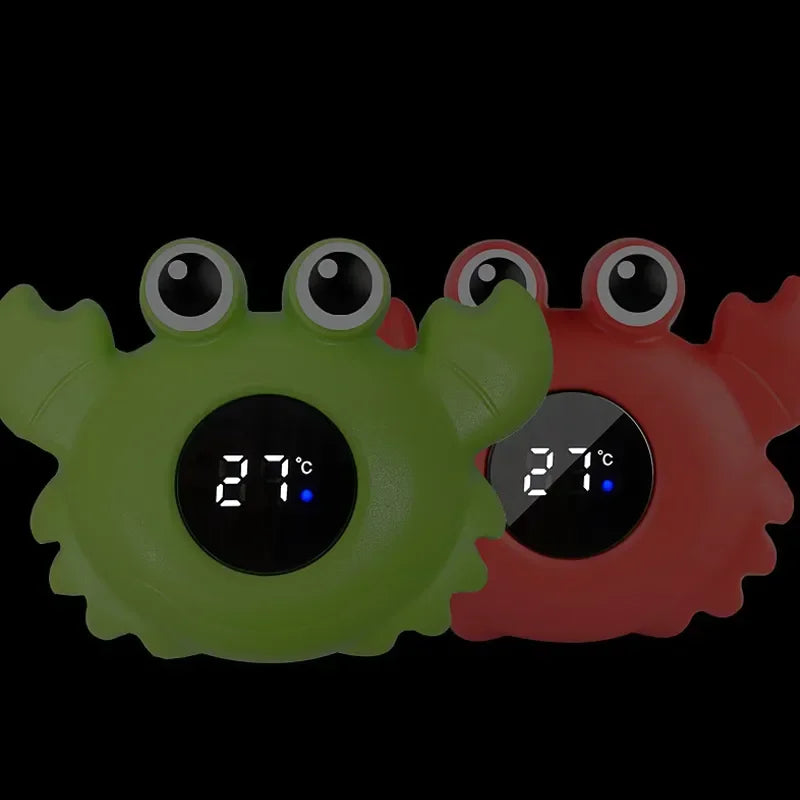 Two crab-shaped digital thermometers, one green and one red, displaying a temperature of 27 degrees.