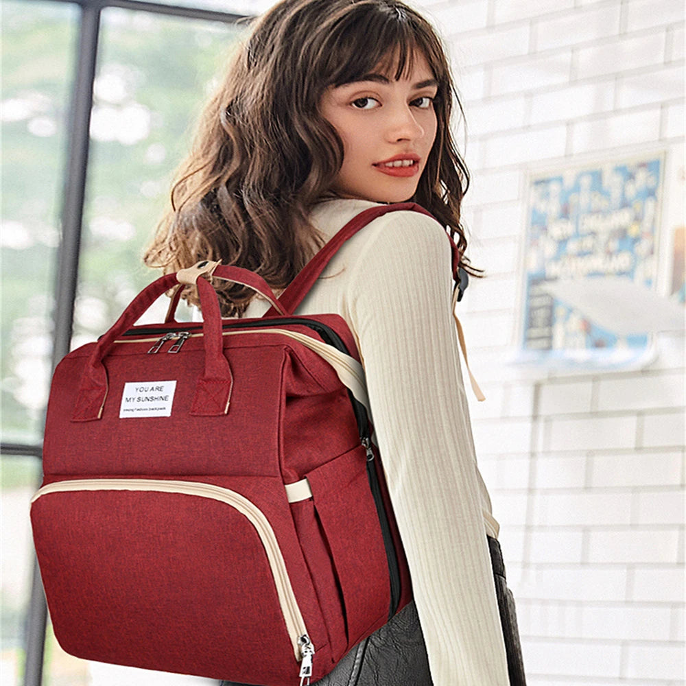 Foldable bed diaper bag with changing station