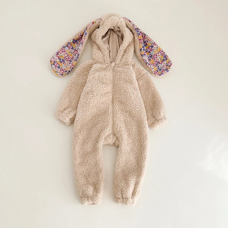 Fluffy beige bunny onesie with floral arm cuffs on a light background