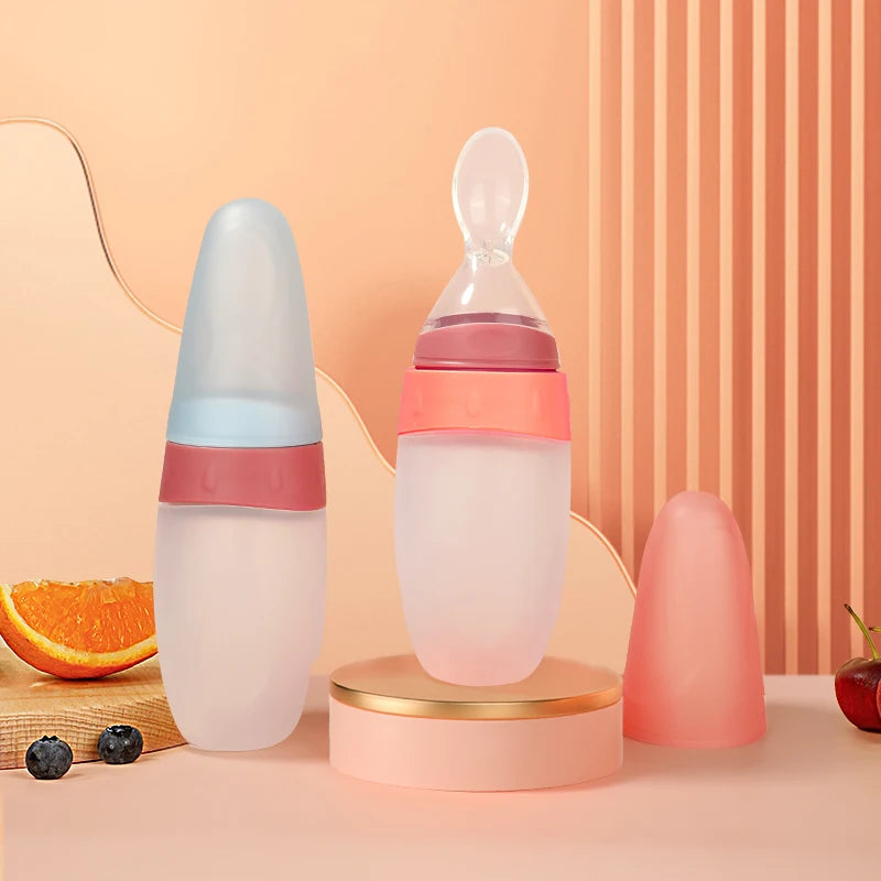Two baby bottles with gradient designs on a peach-colored background