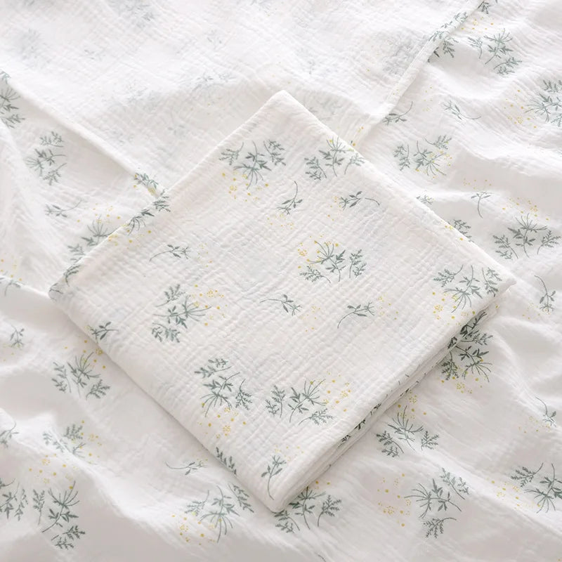 Floral patterned quilt on a white background
Soft cotton muslin swaddle blanket for newborn baby comfort – Winnebaby